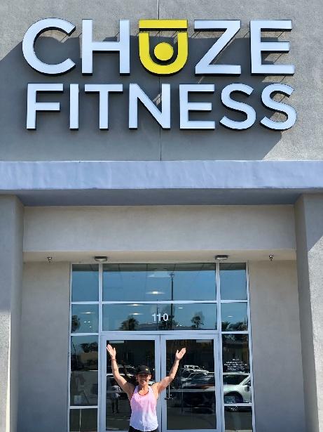 Group Exercise Instructor, Blanca Ramirez, in front of the entrance doors at Chuze Fitness