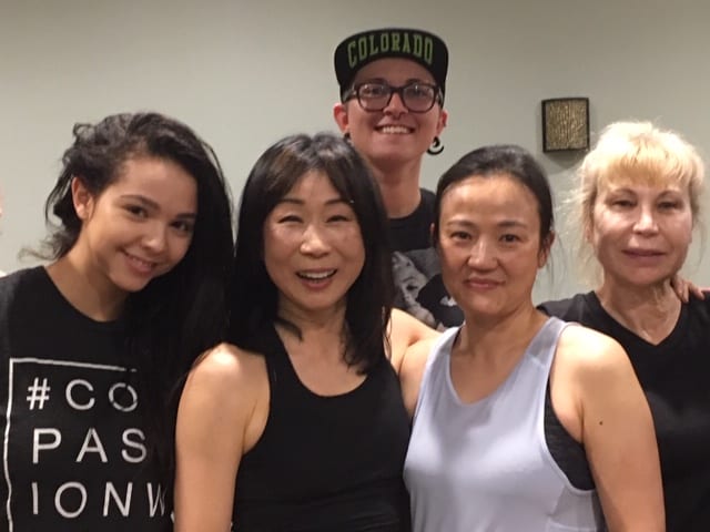 Instructor, Yuko Caruso, and Chuze Fitness members after a yoga class in The Studio
