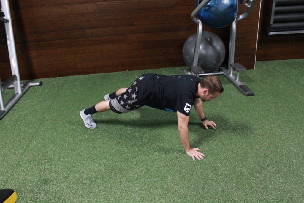Man demonstrating the bodyweight hiit workout inch worm 
