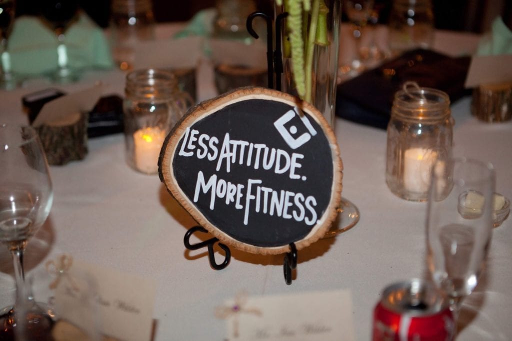 The centerpiece at Nate and Julia's wedding that says "Less Attitude. More Fitness."